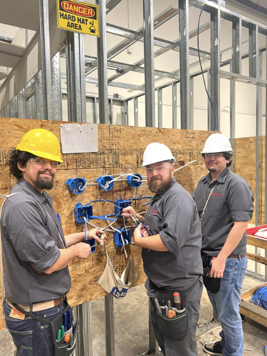 Electrical Technician students working on a wiring board