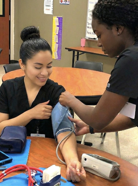 Medical Assistant students practicing blood pressure measurement