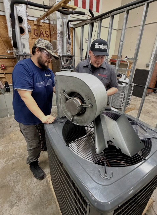 HVAC students servicing a commercial condenser unit